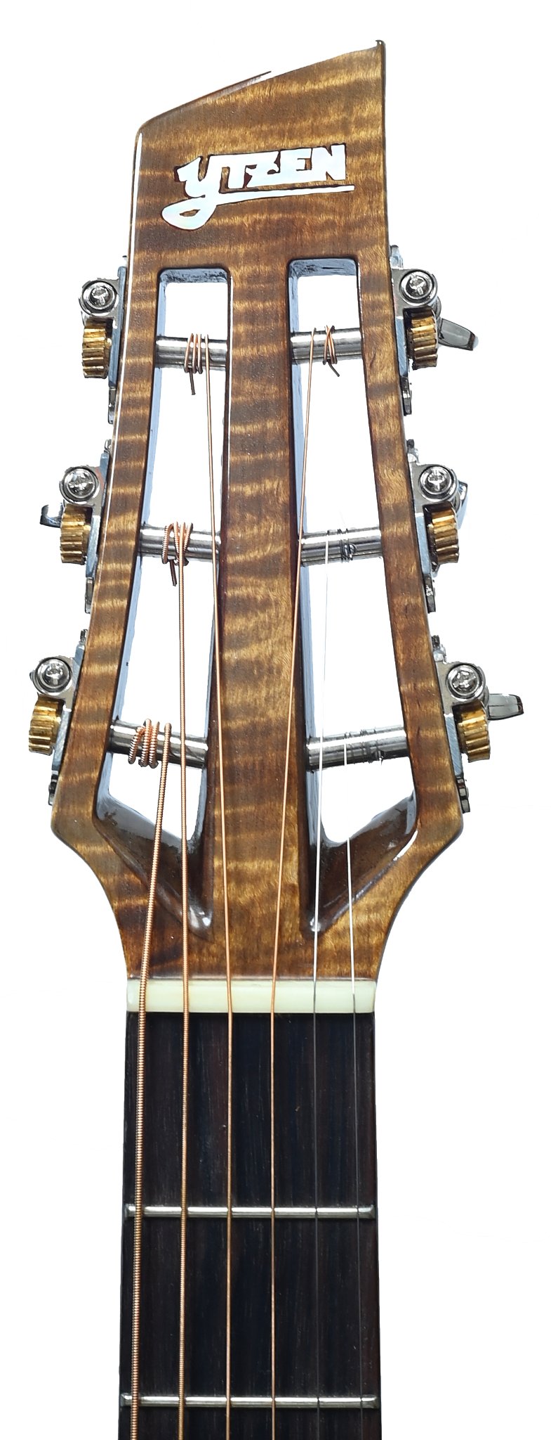 Figured wood Ytzen guitar headstock in a warmly lit workshop